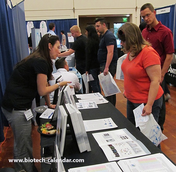 Scientist Examines Lab Equipment Options at University of California, San Diego Biotechnology Vendor Showcase™ Event