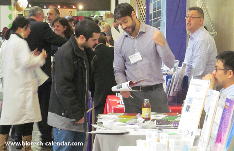 Bioscience Lab Scientist Looks Over Lab Supplies Offered by Rep at Mount Sinai, School of Medicine BioResearch Product Faire™ Event