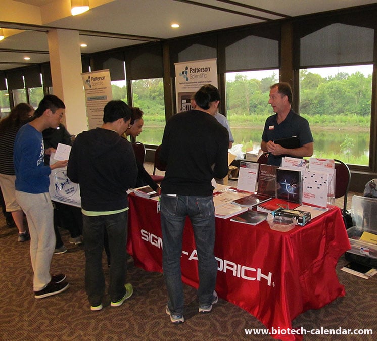 A Sigma-Aldrich representative discussing current events and products with lab researchers in Columbus, Ohio.