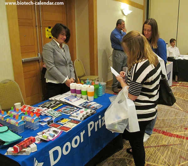 Life-science researchers examine the door prizes after a long day at the University of Cincinnati BioResearch Product Faire™ event