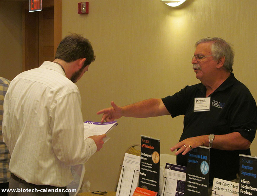 Vendors explain life science information posted in a pamphlet about products and services at the BCI event in Cincinnati.