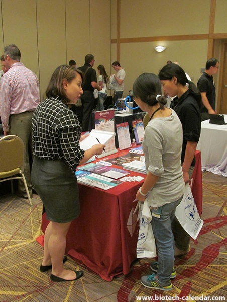 A vendor discusses current events and lab technology with researchers at the University of Cincinnati BioResearch Product Faire™ Event.