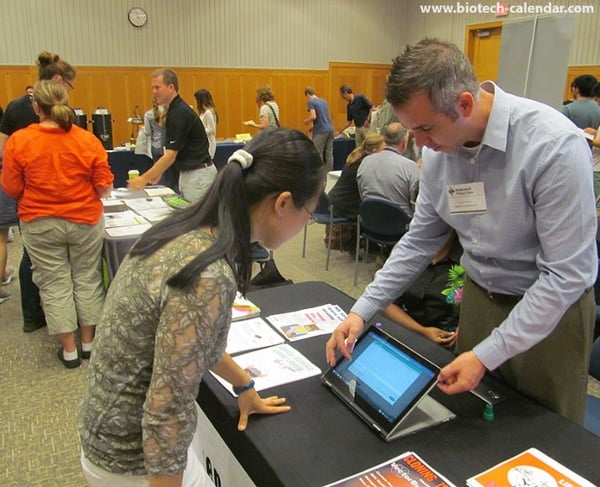 A vendor uses a tablet computers to display new events and laboratory products available at the BioResearch Product Faire at the University of Michigan.